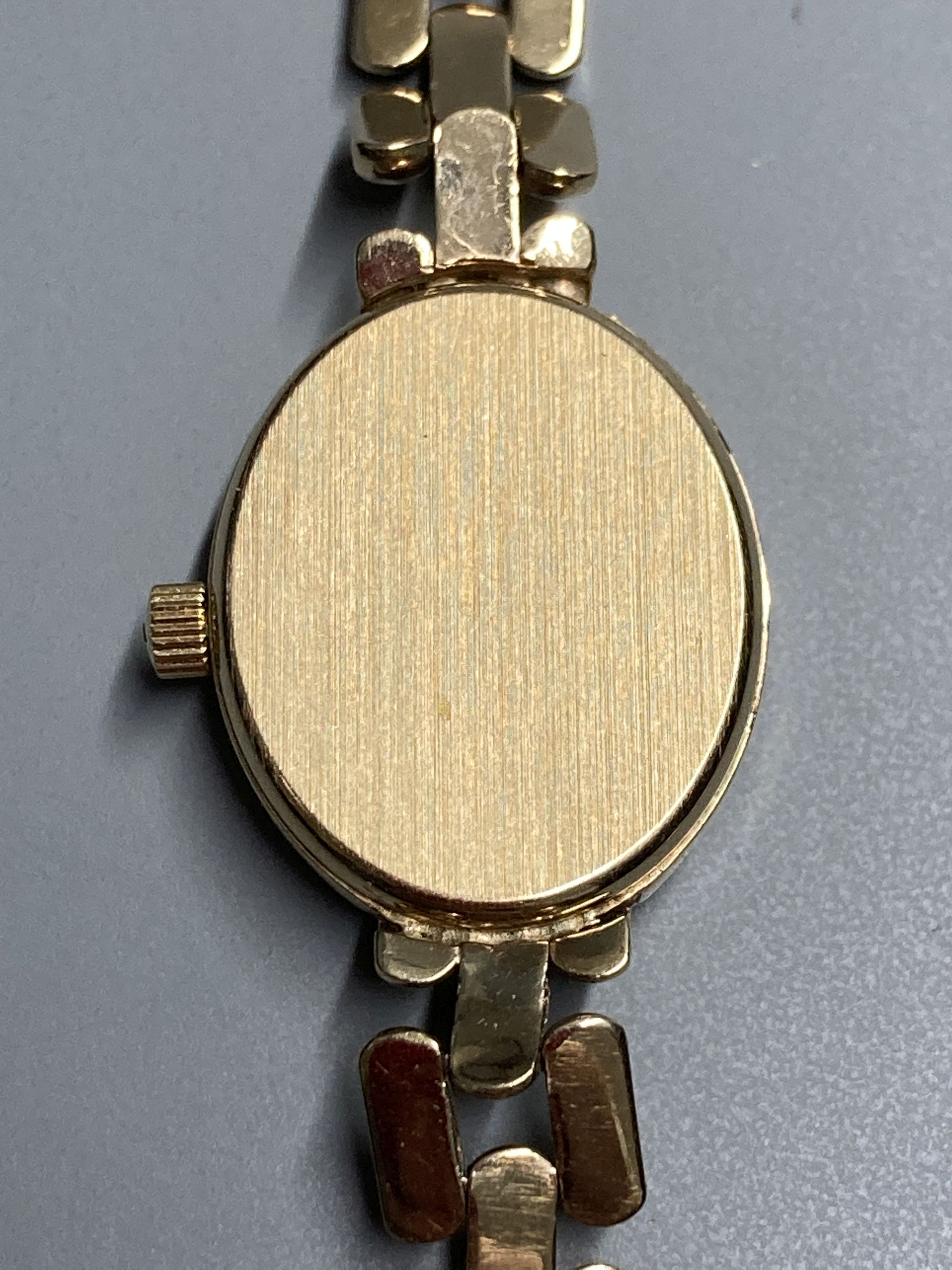 A ladys modern 9ct. gold quartz wrist watch with 9ct gold strap, gross 14.7 grams.